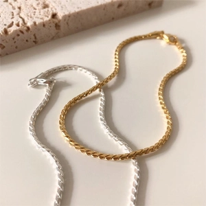 Detail of gold and silver S925 sterling silver snake chain bracelets with lobster clasps