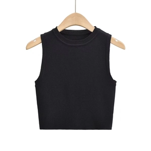 Detailed macro view of the black ribbed knit fabric and texture on the cropped tank top