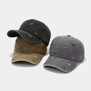 Washed cotton baseball caps with embroidered puppies in black, khaki, and gray colors