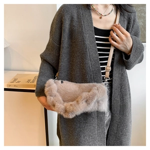 Detailed view of plush faux fur crossbody bag in khaki with adjustable shoulder strap