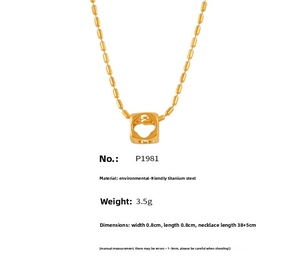 Macro detail of gold plated titanium square hollow pendant on round bead chain