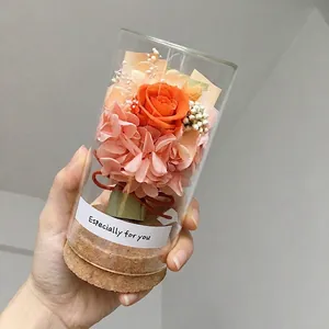 Preserved orange rose in mini glass dome with cork base and pink hydrangea bouquet