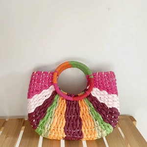 Colorful hand-woven crescent straw bag with vibrant stripes and round handles