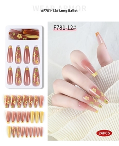 Long ballerina press-on nails featuring orange gradient with yellow floral French design