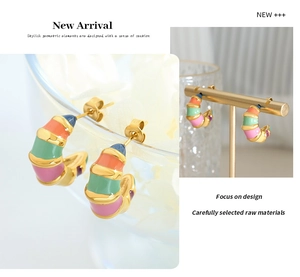 Detailed macro view of colorful enamel C-shape hoop earrings with gold striped segments
