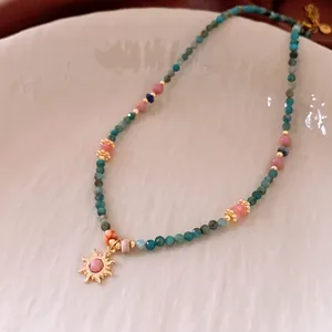Vintage beaded sun pendant necklace with turquoise and pink stones in ethnic boho style