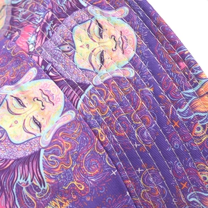 Detail of psychedelic abstract face print and stitching on colorful bucket hat fabric