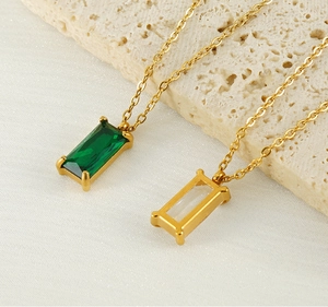 Detail of 18K gold plated stainless steel necklaces with green and clear zircon pendants