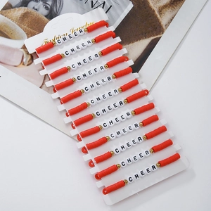 Detail of 12-piece red and white cheerleading friendship bracelets with CHEER letter beads