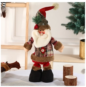 Detail of a plush Santa figurine with a tall red hat and textured plaid coat decoration