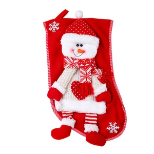 Red knitted Christmas stocking featuring a 3D snowman doll with snowflake patterns