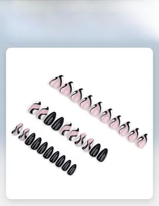 Detail of short almond press-on nails featuring black and pink fluid swirl textures
