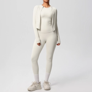 Three-piece cream yoga set featuring a zip jacket and high-waisted leggings in high-stretch fabric