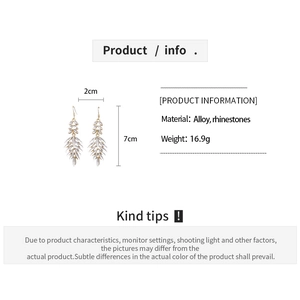 Detail showing leaf-shaped tassel earrings with rhinestones and precise dimensions