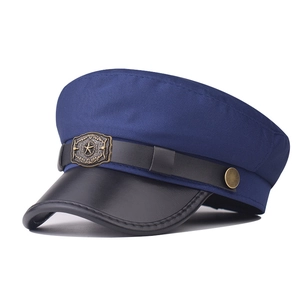 Detail of navy cotton military cap featuring black PU leather brim and gold star badge