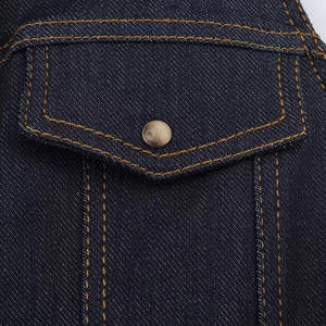 Detail of dark blue denim bodysuit showing pocket with contrast stitching and metal button