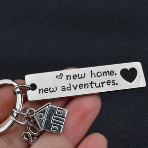 Polished silver stainless steel keychain with house charm and new home adventure engraving