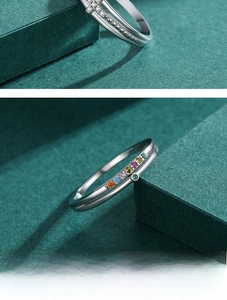Detail of S925 silver rings featuring a pavé cross and rainbow colorful zircon stones