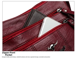 Deep red crossbody bag featuring multiple zipper pockets and a textured leather surface