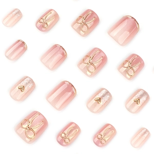 Short square pink cat eye press-on nails with 3D gold bow and heart accents