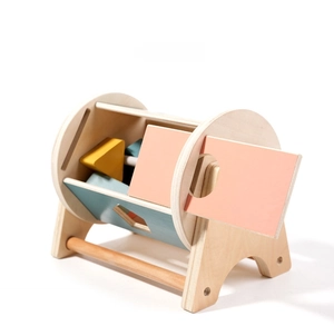 Detail of wooden montessori shape sorter toy with macaron colored lid and blue block