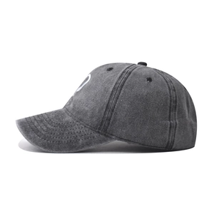 Side view of washed grey cotton baseball cap showing distressed texture and stitching