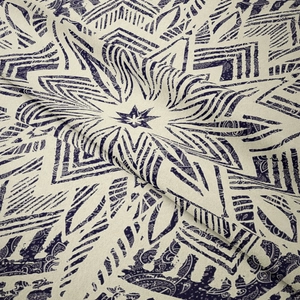 Close-up of the woven texture and intricate purple mandala print on bohemian fabric