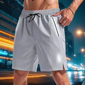 Detail showing the reflective Gutz Wear logo and hidden zipper pocket on men's running shorts