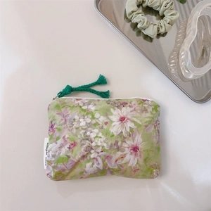 Detail of floral oil-painting cotton pouch with green tassel and simple wish label