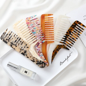 Detail of multi-color acetate wide-tooth hair combs in elegant silk setting