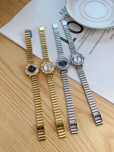 Detailed macro view of vintage flower-shaped watches in gold and silver finish