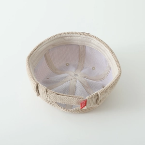 Detailed interior of beige knit docker hat showing soft lining and red DIDI CUTE label