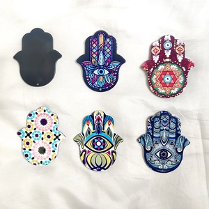 Close-up of 6 colorful acrylic Hamsa Hand pendants with Evil Eye and mandala designs