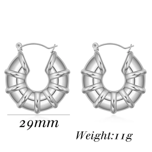 Detailed macro view of 29mm ribbed silver U-shaped earrings in polished stainless steel