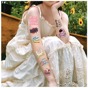 Detail of waterproof temporary reading tattoos on arm in a sunny garden setting