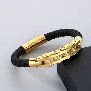 Mechanical braided leather bracelet with golden gear accents on a black display box
