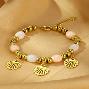 Close-up of a colorful beaded titanium steel bracelet with three golden scallop pendants