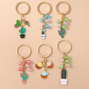 Set of colorful beaded cactus keychains with gold metal rings and enamel pendants