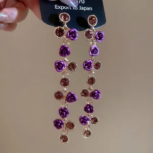 Elegant long tassel drop earrings featuring purple roses and brown crystals on gold finish