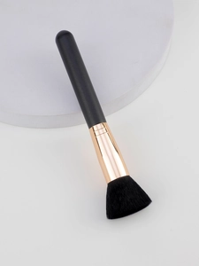 Detail of soft black bristles and rose gold ferrule on a multi-use makeup brush
