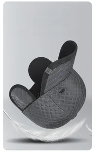 Detail of grey quilted winter baseball cap featuring ear flaps and heat storage lining
