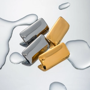 Minimalist 18k gold and silver stainless steel rectangular earrings on mirror water surface