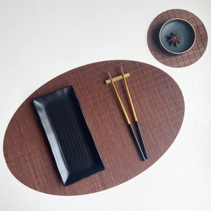 Handwoven brown bamboo tea mat set with oval and round heat-resistant coasters