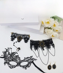 Detail of Gothic black lace jewelry set with mask, choker, earrings and finger bracelet