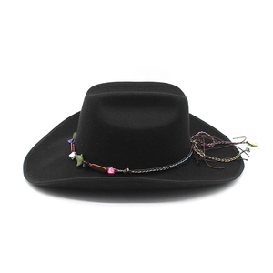 Detail of ethnic style woven band with colorful stones and tassels on a black felt cowboy hat