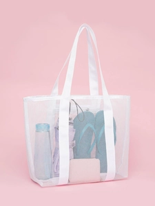 Close-up of white mesh beach bag showing spacious interior with storage essentials