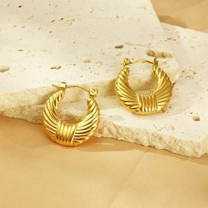Detailed view of gold 18k stainless steel U-shaped croissant earrings with striped texture