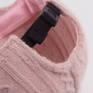 Pink knit baseball cap featuring a warm cable knit texture and adjustable back buckle