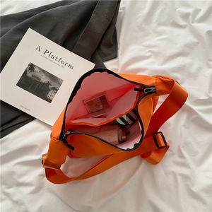 Large orange nylon crossbody bag with dual zipper compartments and spacious interior