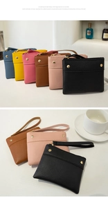 Detailed view of colorful PU leather coin purses with gold zippers and wrist straps